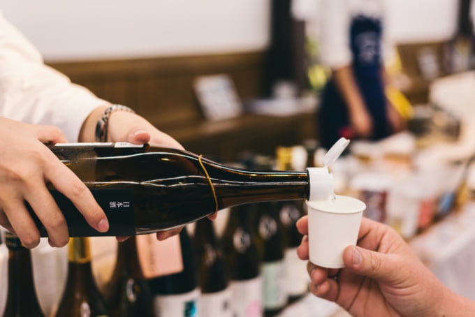 pouring a glass of Japanese sake or nihonshu