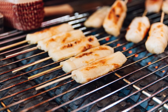 Grilled Mochi Sticks on gas griller stove, street food at Ximending in Taiwan, Taipei.